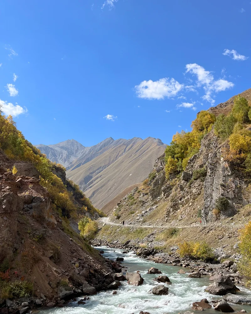 A winding river between sunlit mountain slopes