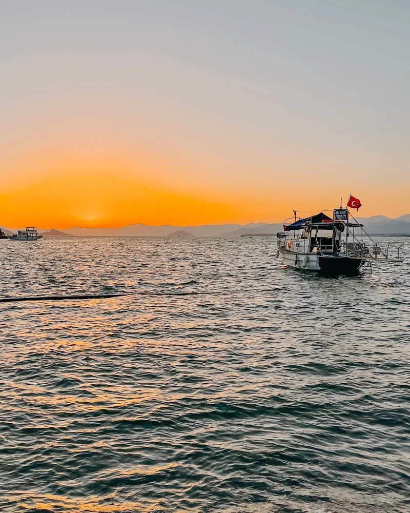 Warm sunset over the sea with a boat on the horizon